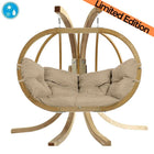 Hanging chair with beige cushions on a white background, featuring a limited edition label.