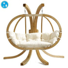 Wooden hanging chair with white cushion on a white background
