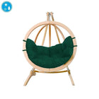 Hanging chair with green cushion and wooden frame on a white background