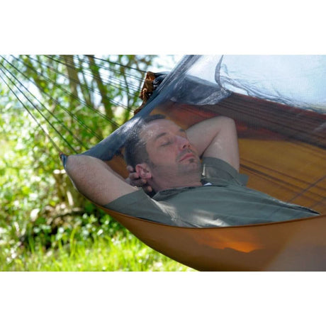 Man relaxing in a hammock with a scenic background