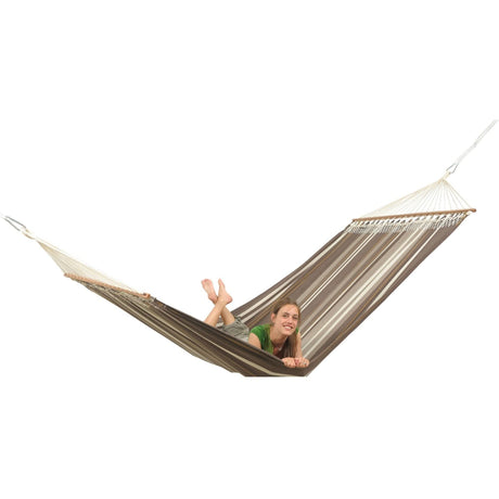Person relaxing in a hammock on a white background