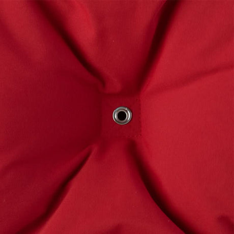 Close-up of a red fabric with a metal button in the centre.