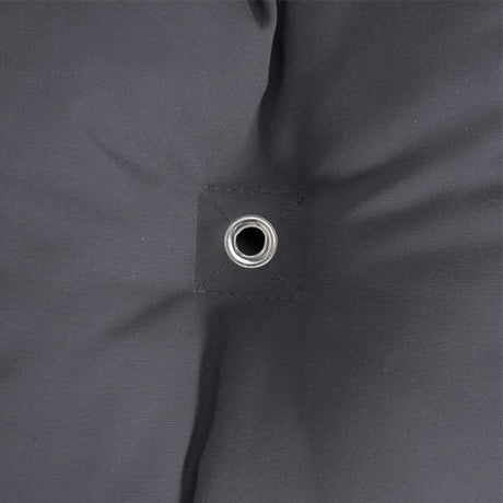 Close-up of a dark grey fabric with a grommet.