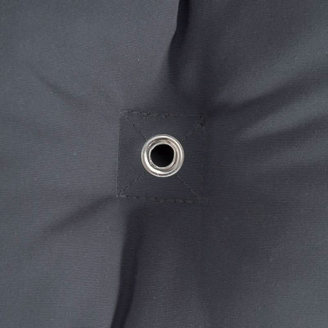 Close-up of a grommet on a dark grey fabric