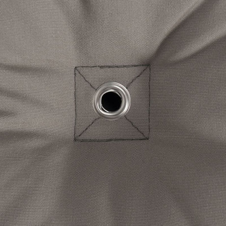 Close-up of a grey fabric with a grommet hole.